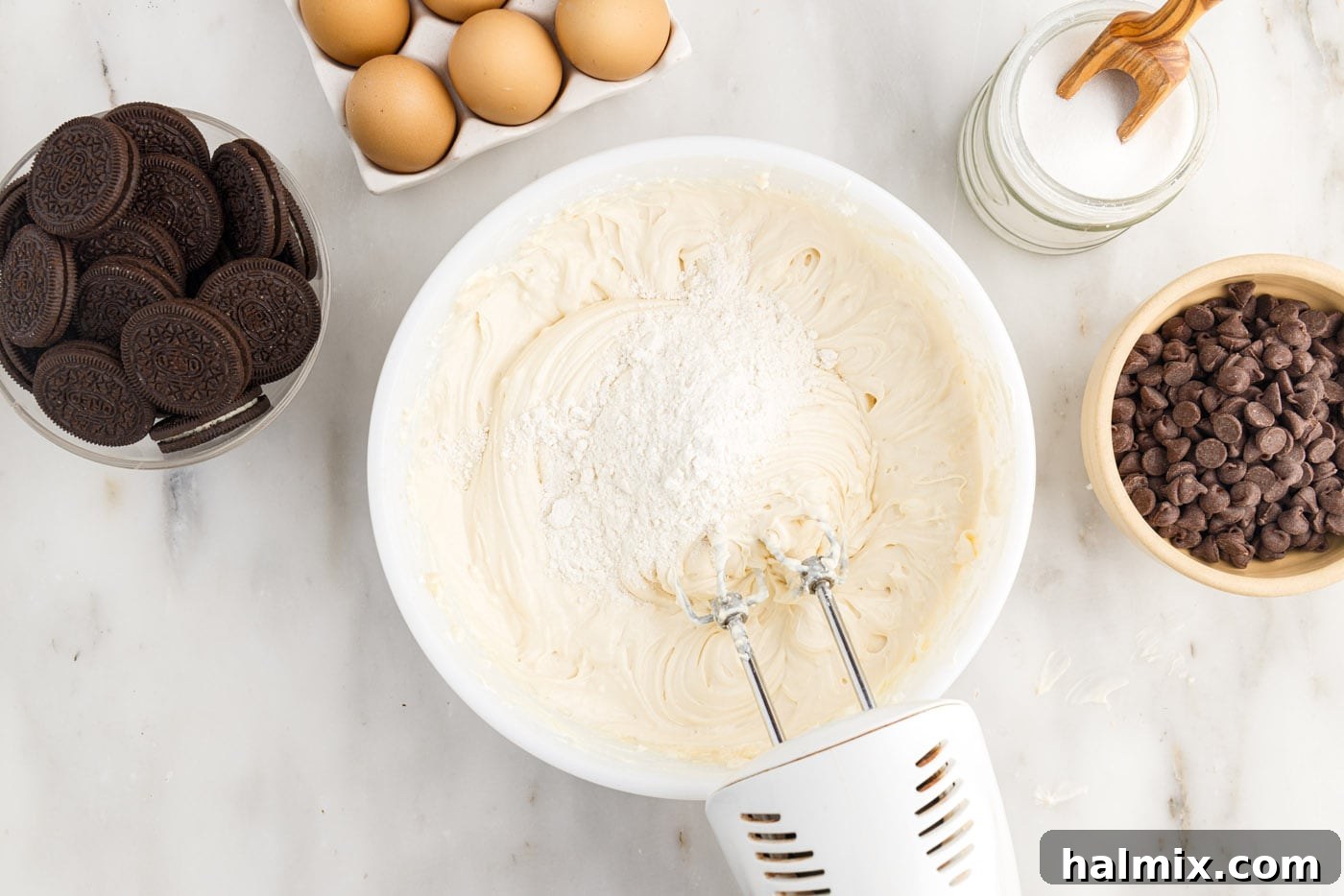 adding flour to cheesecake mixture