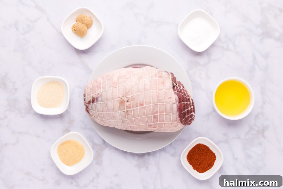 Roasted Leg of Lamb 4 A collection of fresh ingredients laid out for preparing Leg of Lamb, including the lamb roast, spices, and olive oil.