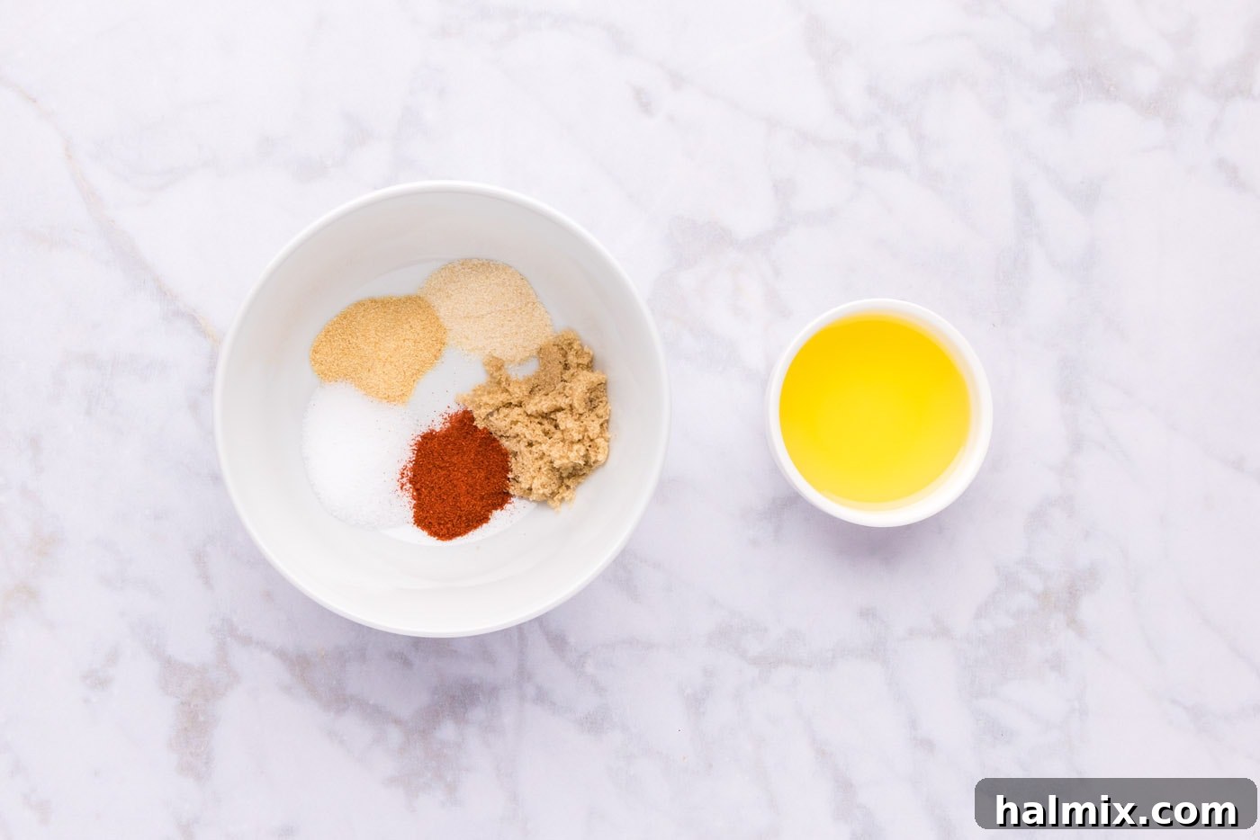 Roasted Leg of Lamb 5 Seasonings in a bowl next to olive oil, ready to be mixed into a wet paste for the lamb.