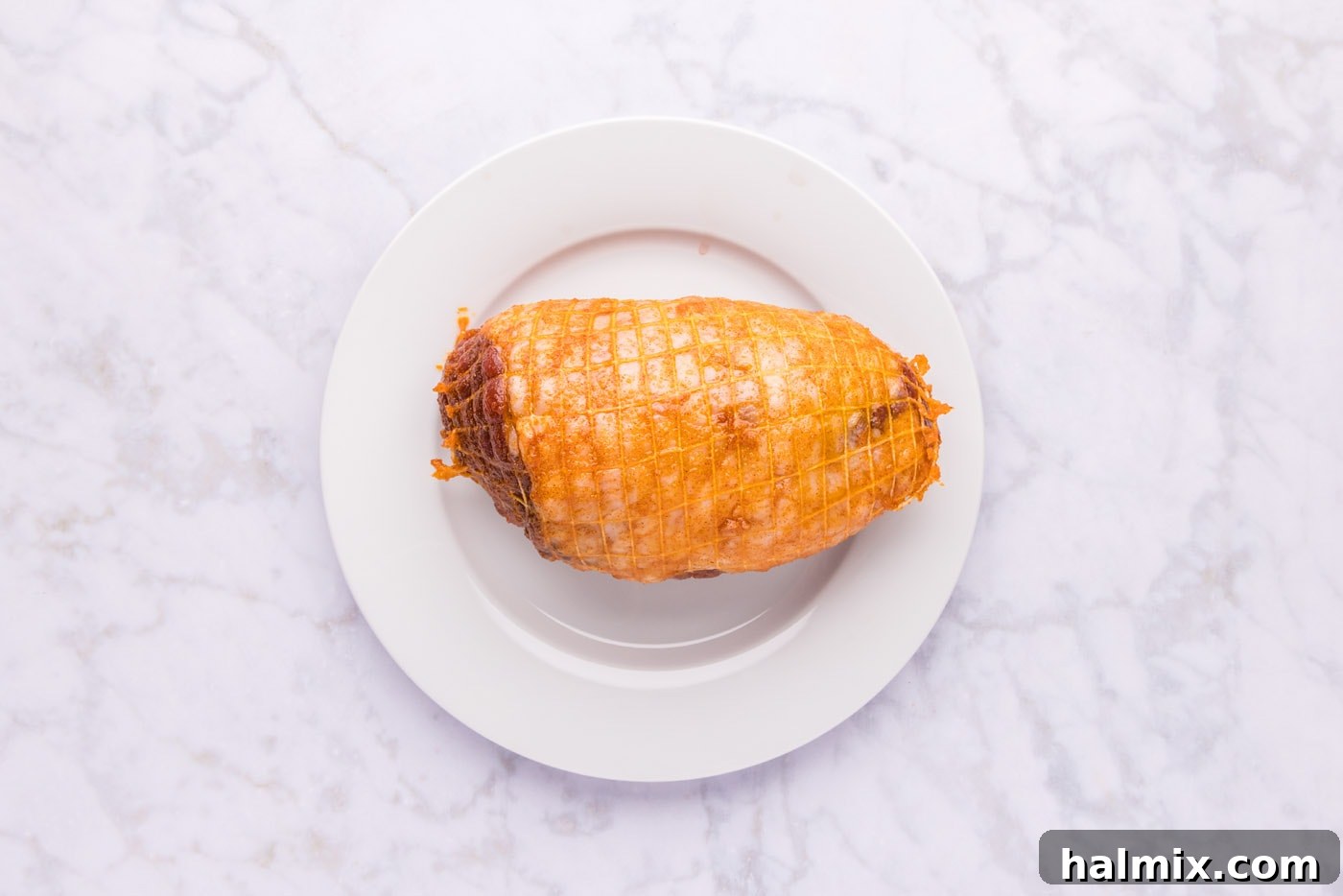 Roasted Leg of Lamb 6 A boneless leg of lamb roast being generously rubbed with the spice paste, ensuring even coverage for maximum flavor.