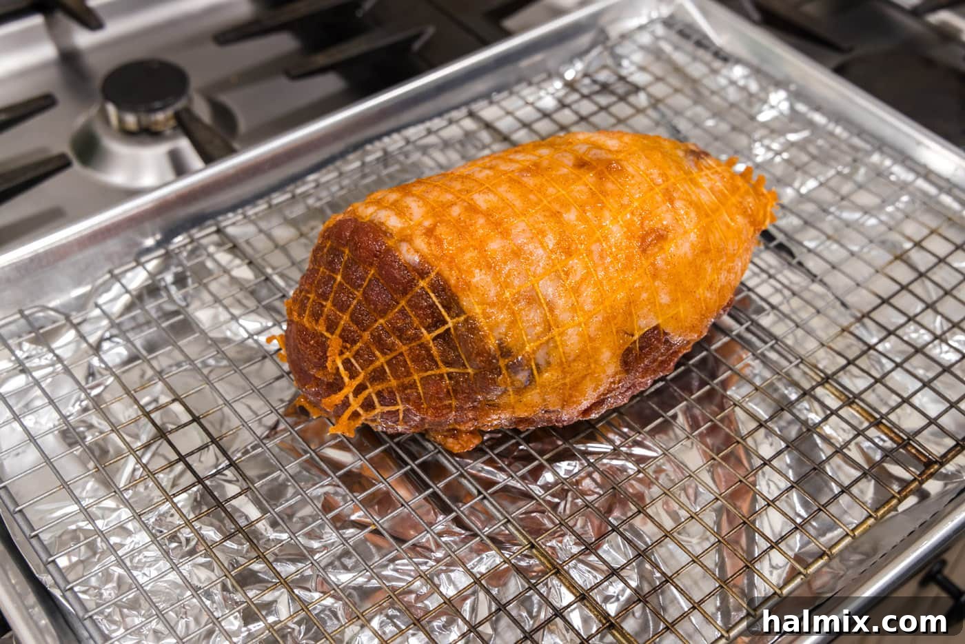 Roasted Leg of Lamb 7 Leg of lamb placed on a wire rack over a foil-lined baking sheet, prepared for roasting.