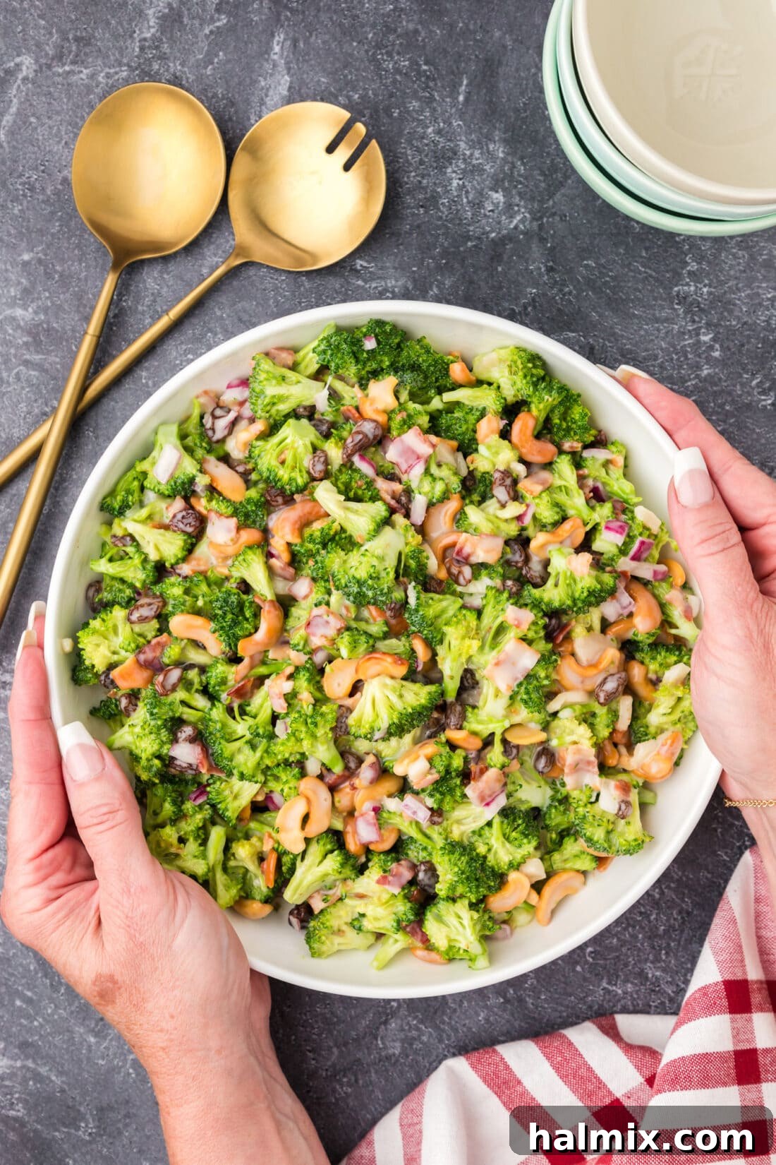 Crunchy Broccoli Cashew Delight 2 Hands holding a bowl of Broccoli Cashew Salad
