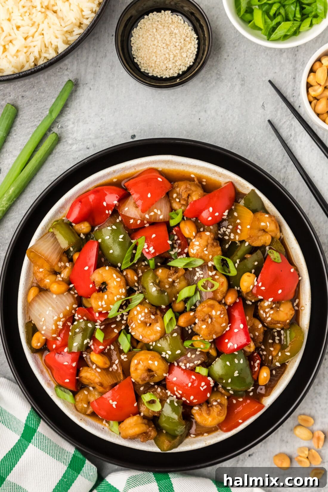 Spicy Kung Pao Shrimp 57 Plate of Kung Pao Shrimp with rice and peanuts on the side