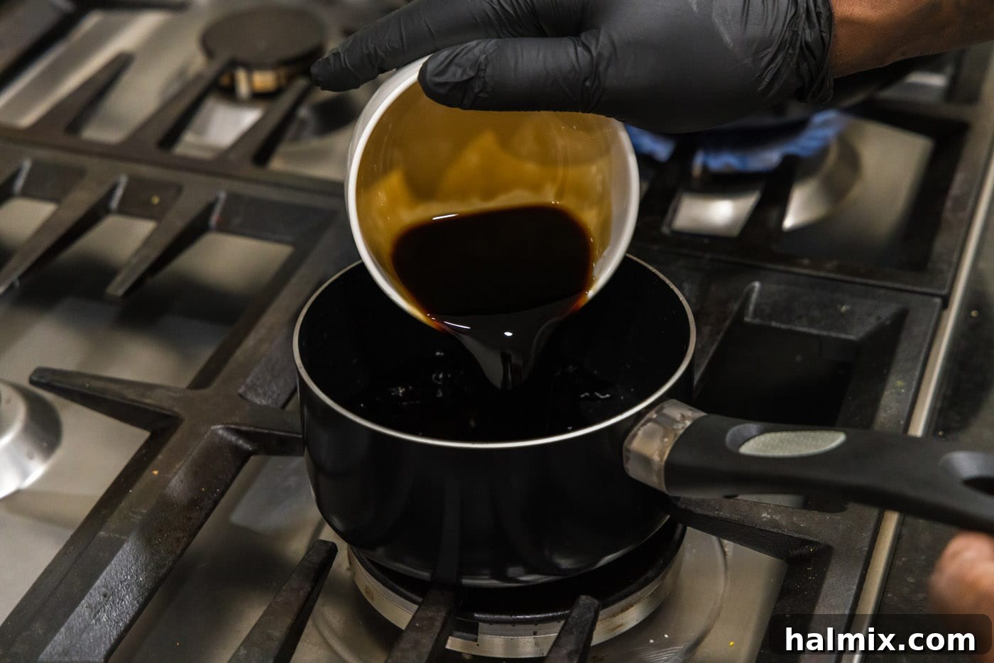 pouring soy sauce into a saucepan