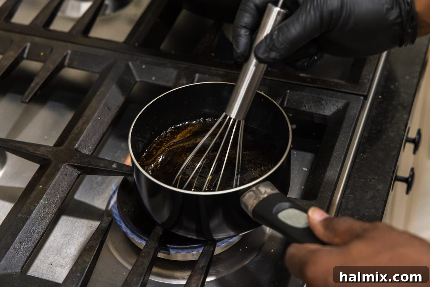 whisking kung pao sauce in a saucepan
