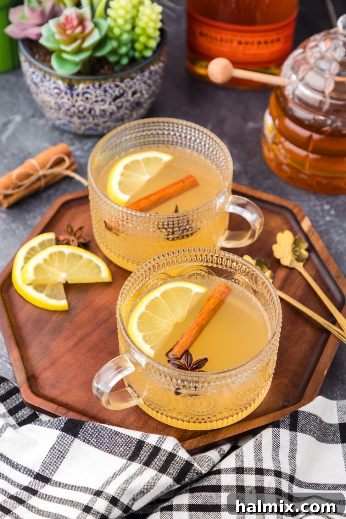 Two Hot Toddy drinks on a wooden serving tray