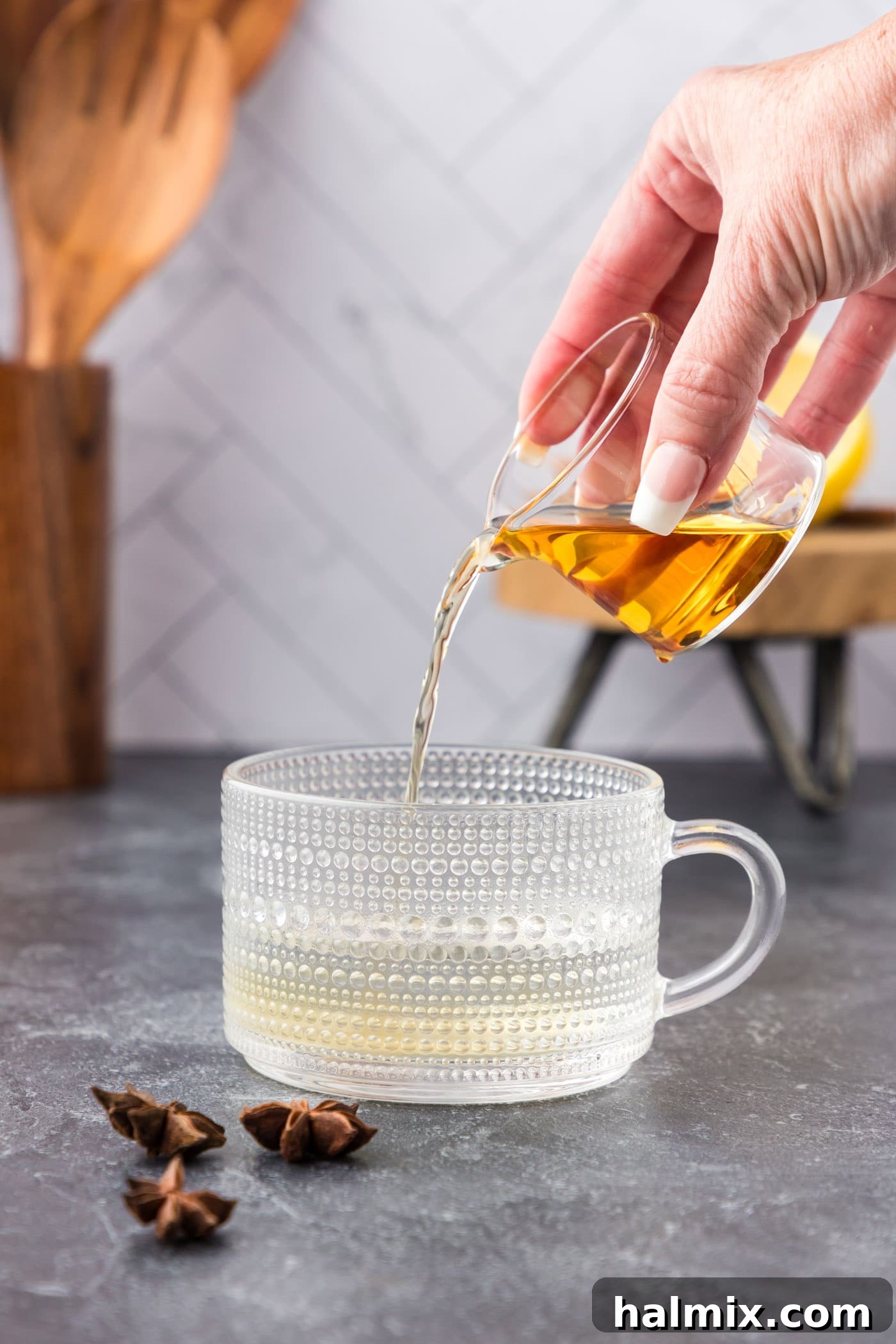 pouring bourbon into mug with water