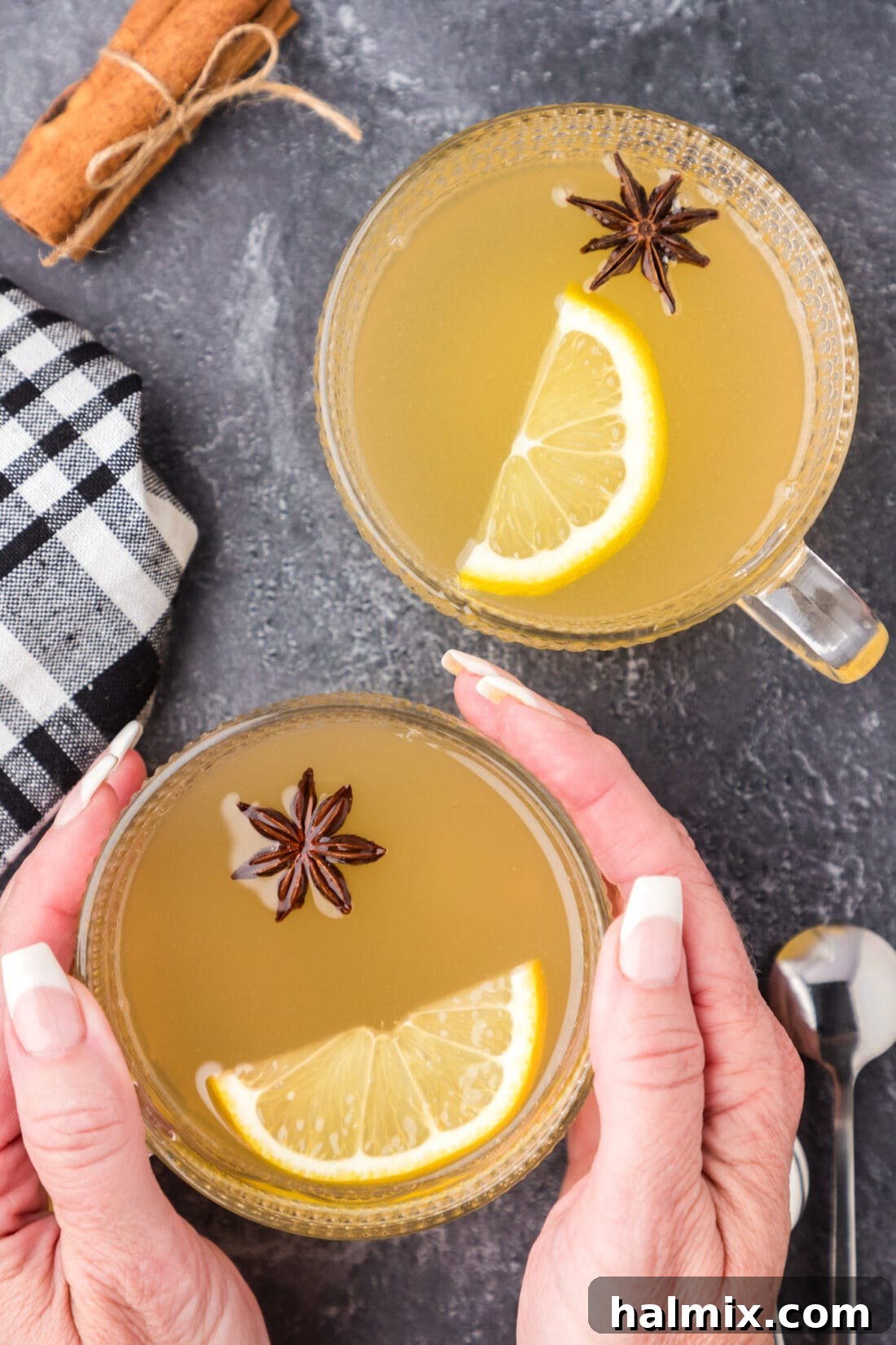 Hands holding a Hot Toddy next to another Hot Toddy