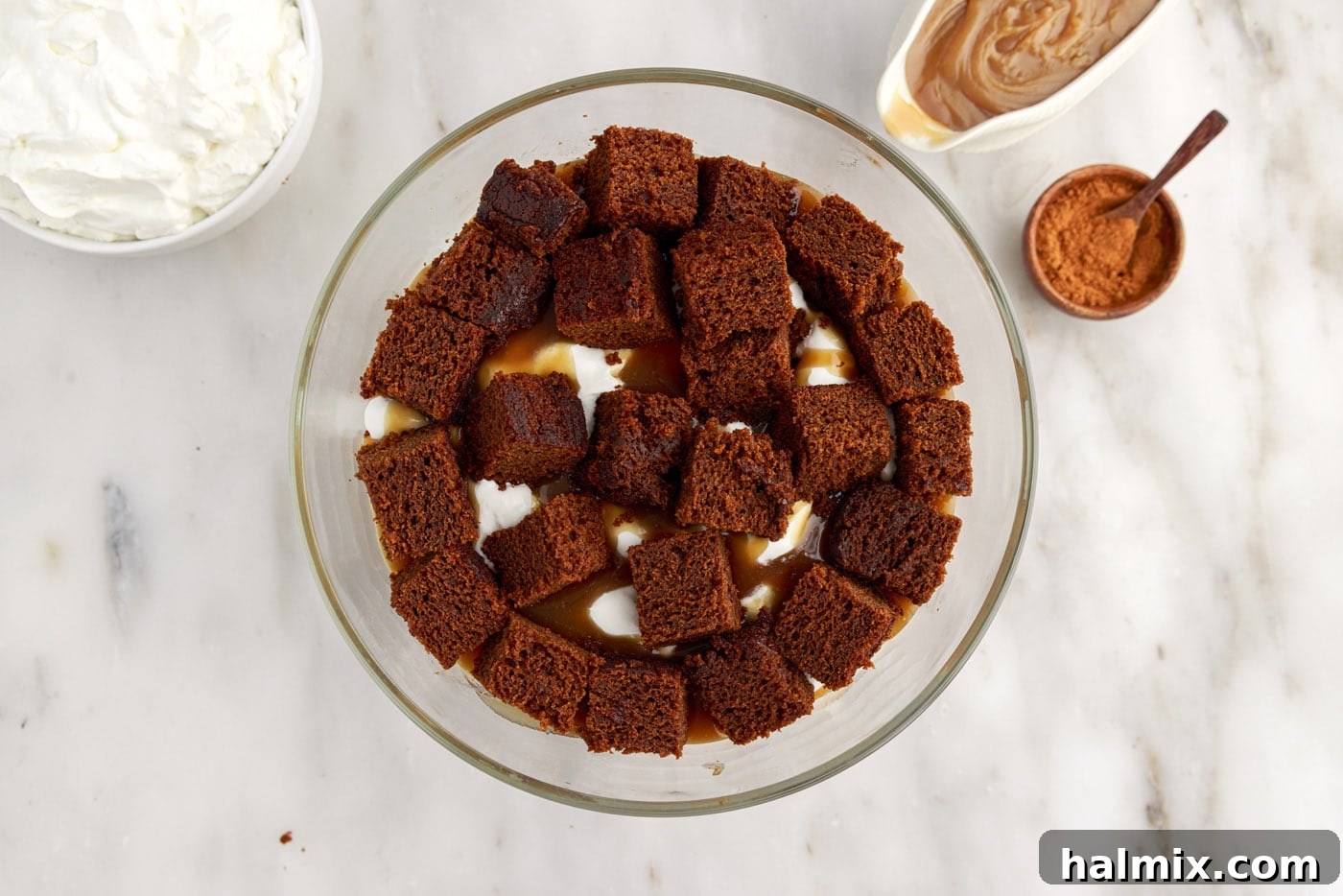More cubed gingerbread cake placed on top of the caramel and whipped cream layers