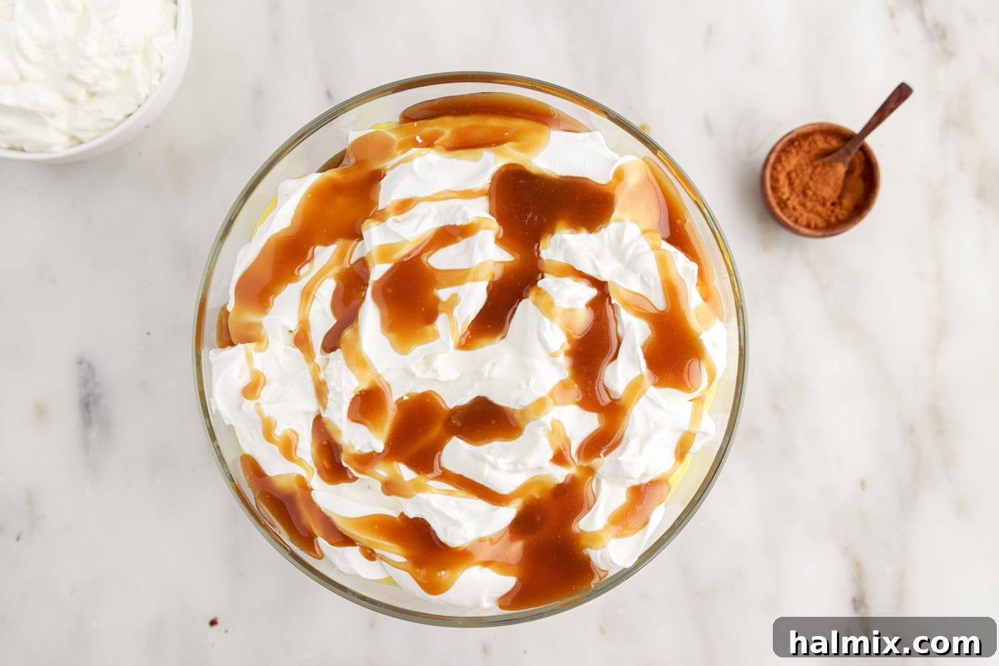 Remaining whipped cream and caramel sauce topping the gingerbread trifle