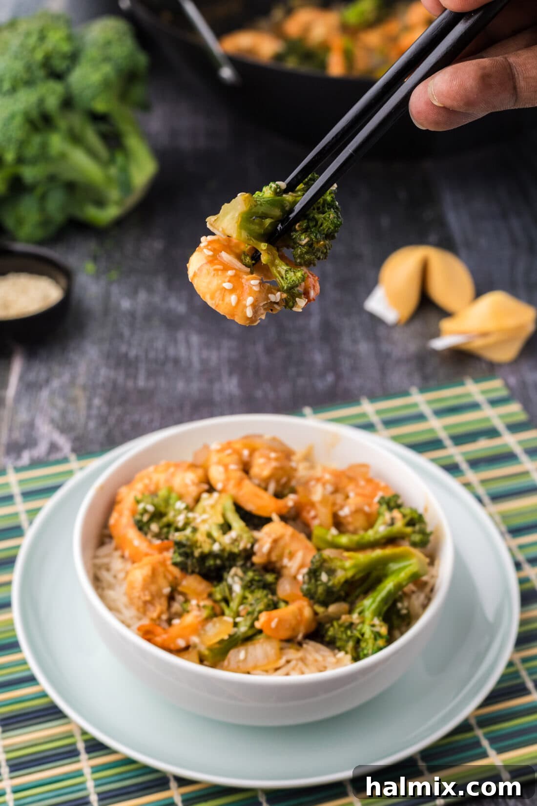 Chopsticks holding up Shrimp and Broccoli