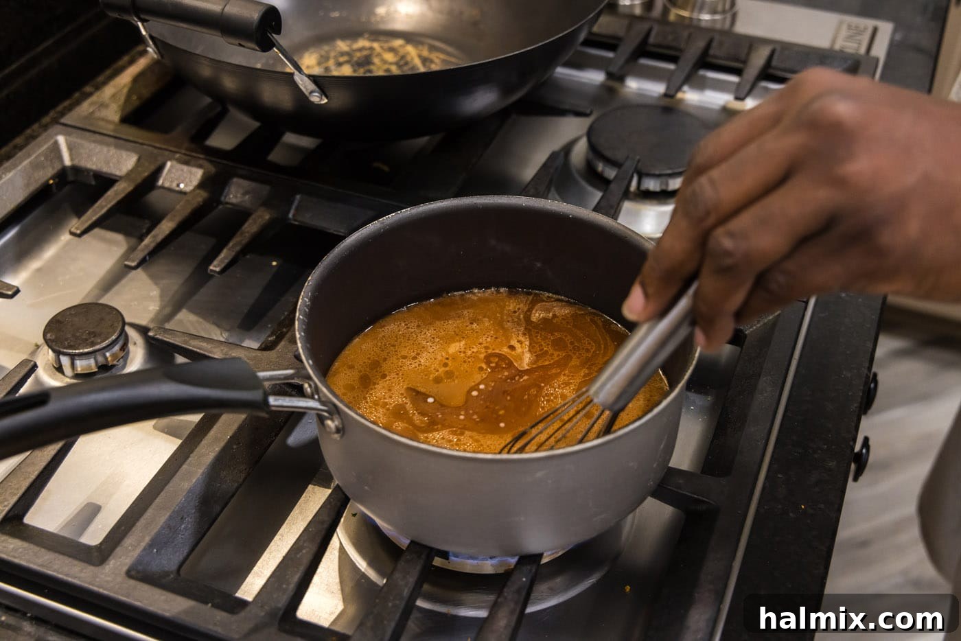 whisking slurry into shrimp and broccoli sauce to thicken