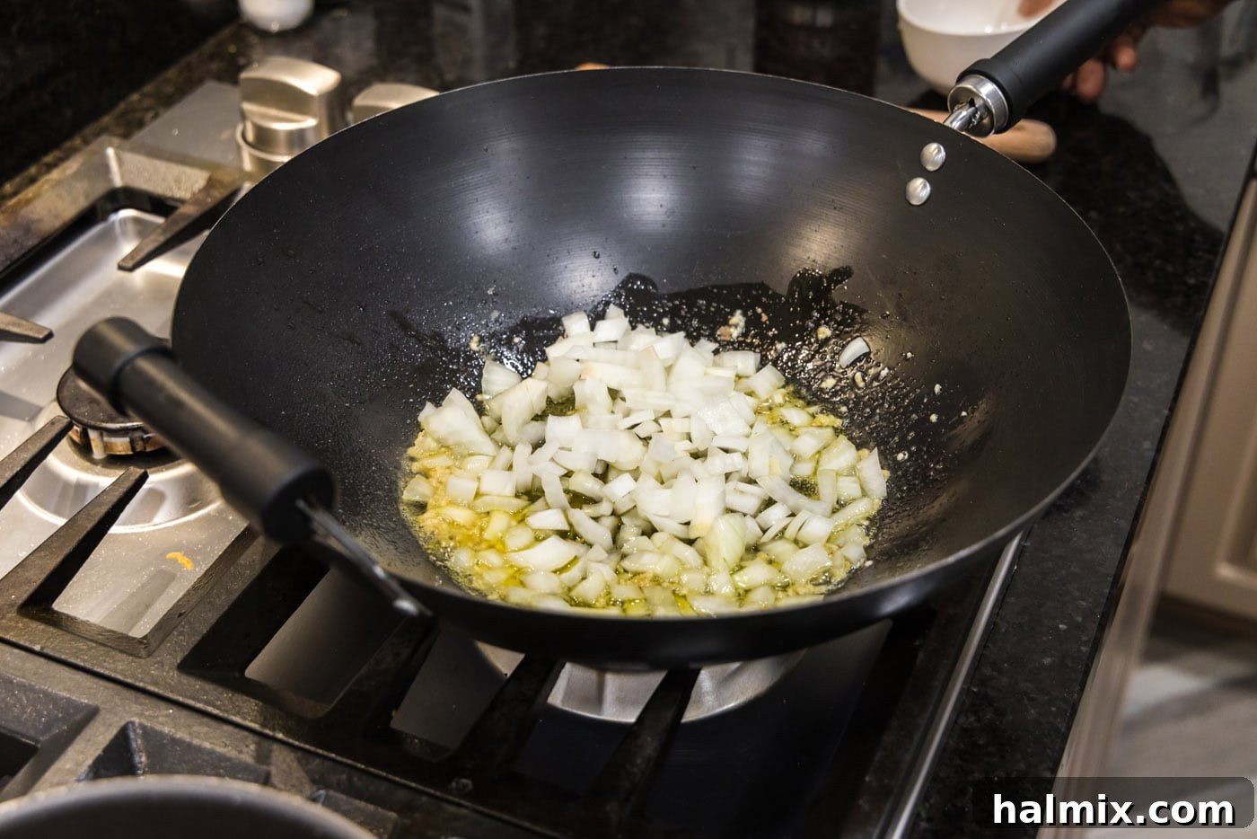 sauteeing onion in a wok