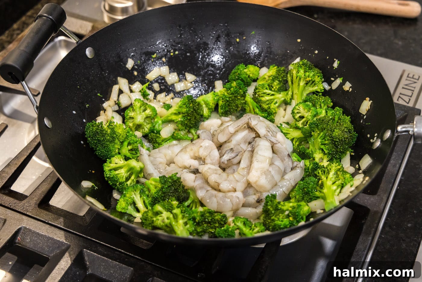 shrimp added to wok with broccoli and onion