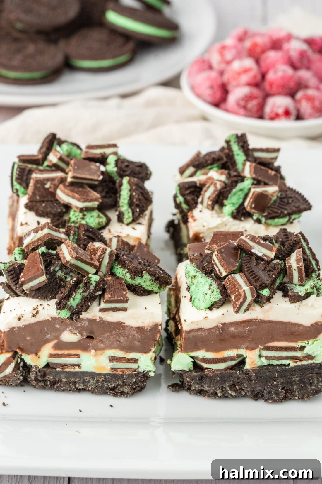 Four perfectly portioned Mint Chocolate Dream Bars displayed on an elegant platter, ready to be served.