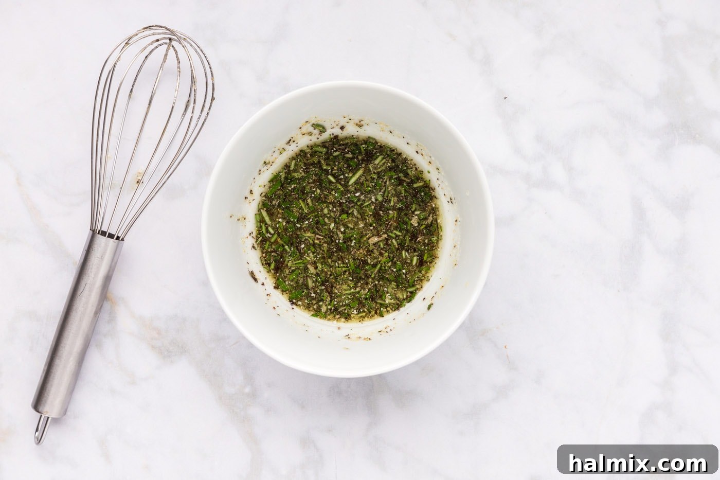 olive oil, rosemary, and seasoning mixture in a bowl