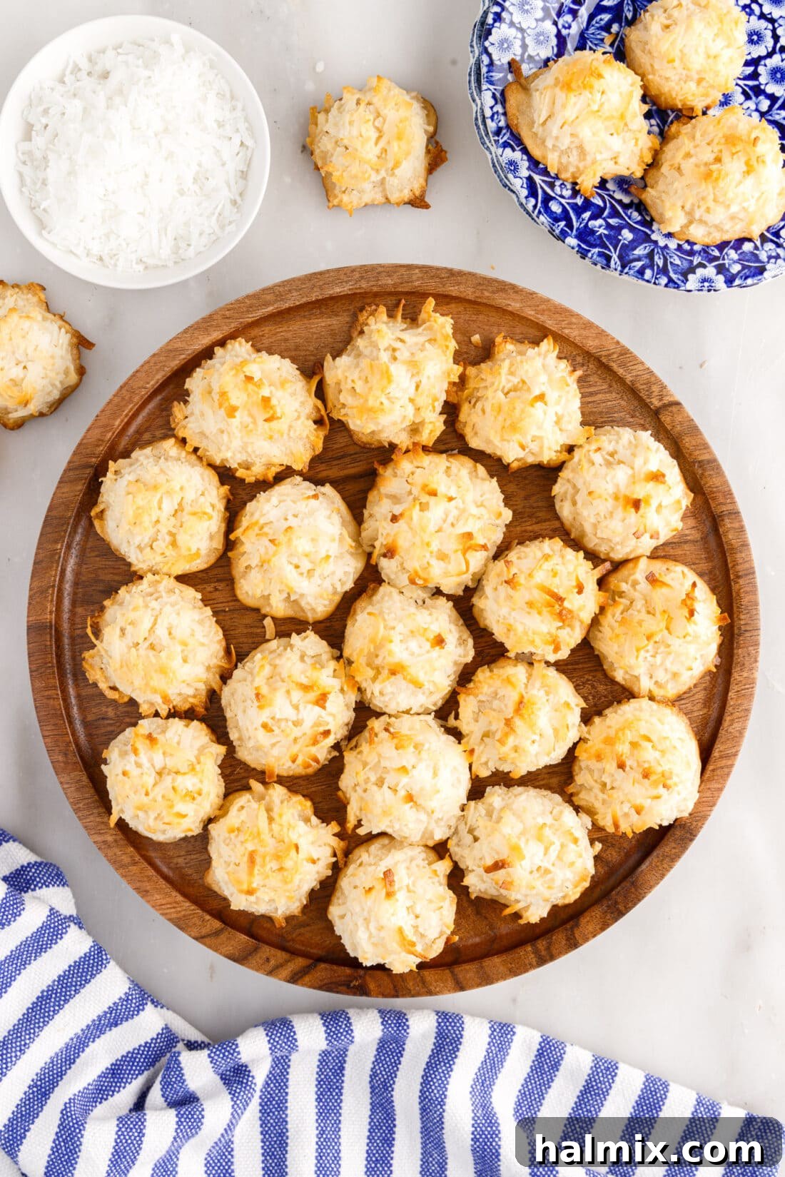 Freshly baked coconut macaroons arranged neatly on a rustic wooden platter, ready to be served and enjoyed.