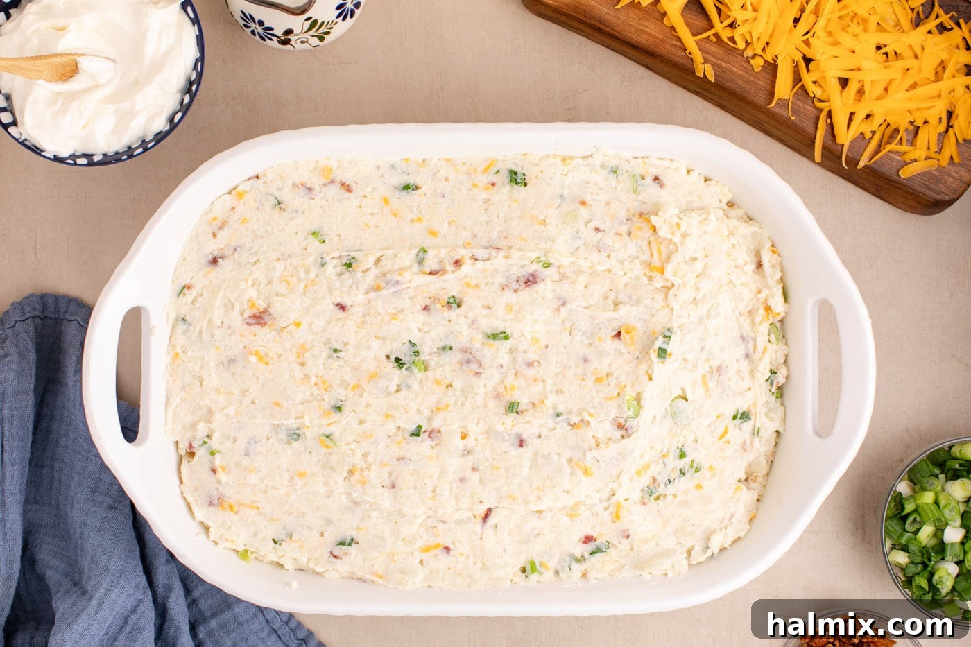 Decadent Twice Baked Potato Casserole 11 Overhead view of the creamy potato mixture evenly spread in a 9x13 inch casserole dish, ready for topping.