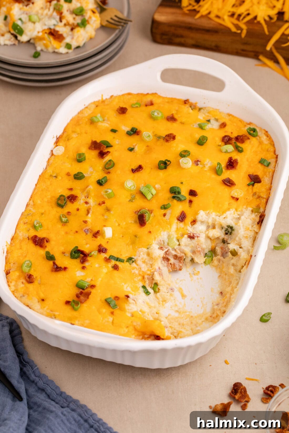 Decadent Twice Baked Potato Casserole 14 A close-up shot of the Twice Baked Potato Casserole with a serving removed, showcasing its creamy interior and delicious layers.