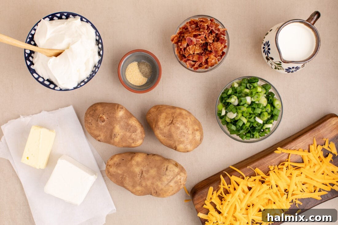 Decadent Twice Baked Potato Casserole 4 A collection of fresh ingredients laid out, including russet potatoes, cream cheese, sour cream, milk, butter, garlic powder, pepper, shredded cheddar cheese, bacon, and green onions, ready for the Twice Baked Potato Casserole.