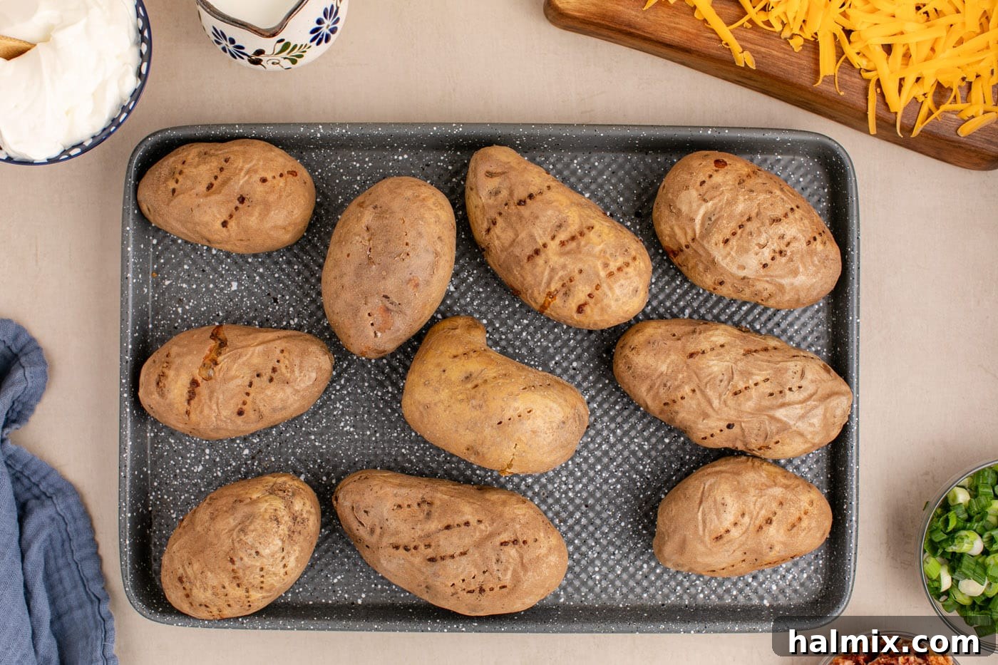 Decadent Twice Baked Potato Casserole 6 Perfectly baked russet potatoes on a baking sheet, golden and tender.