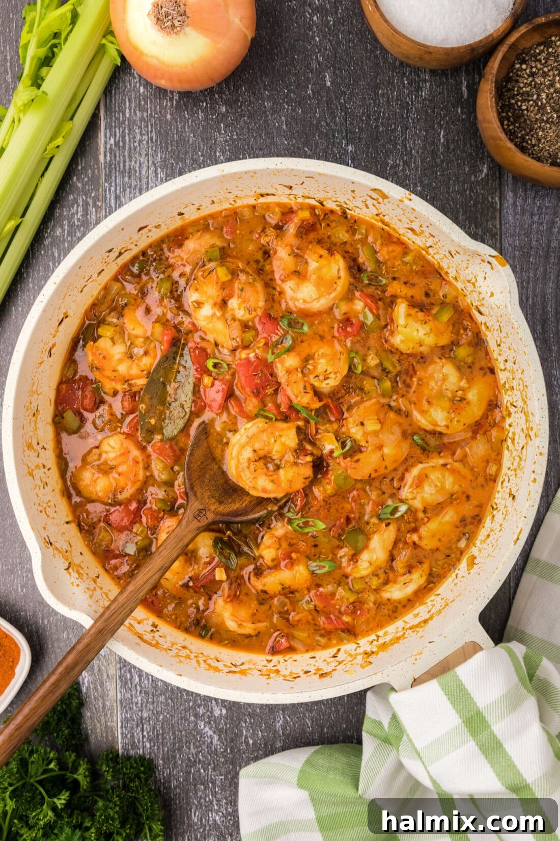 Spicy Shrimp Creole 2 Skillet of Shrimp Creole with a spoon in it, garnished with fresh herbs.