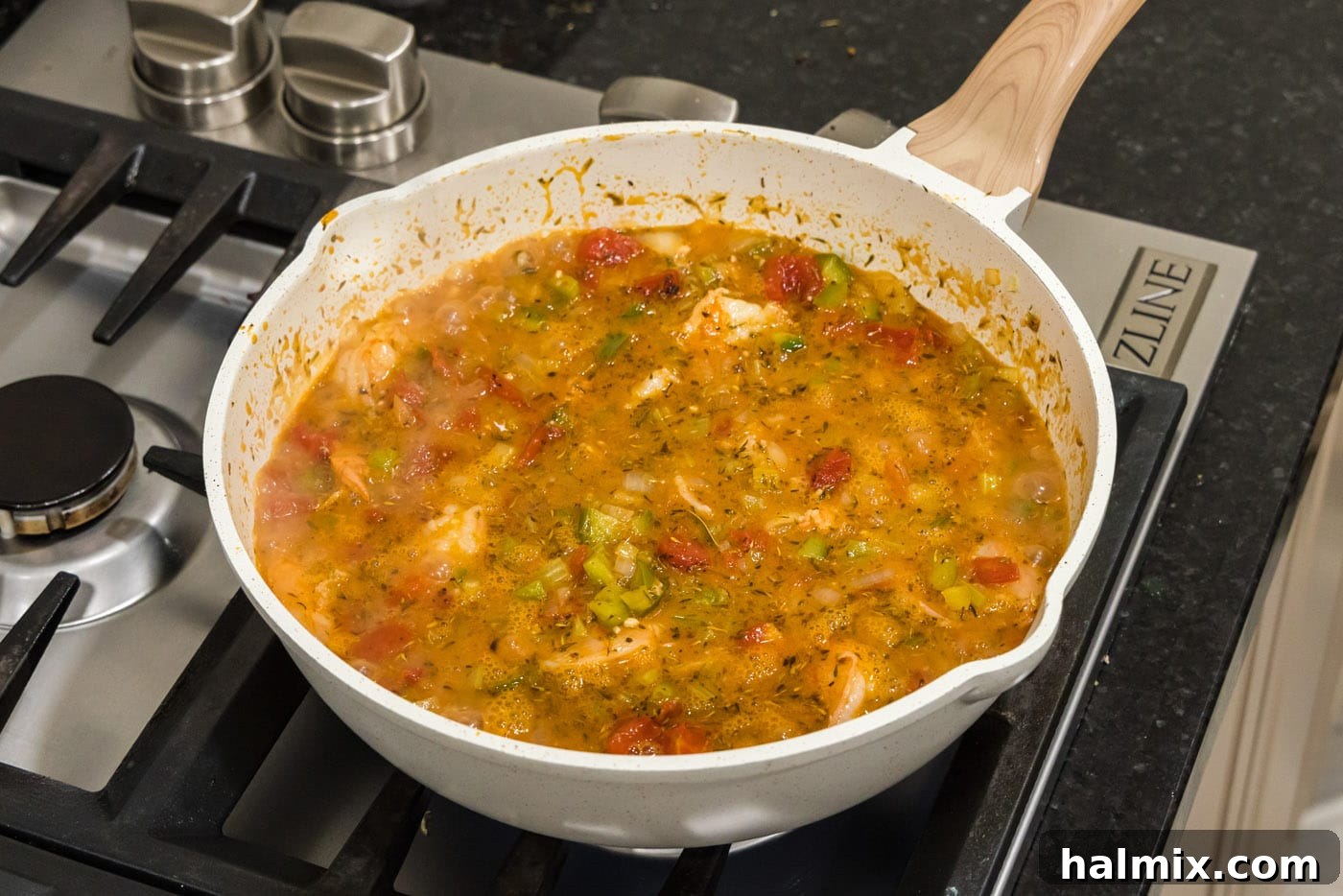 Spicy Shrimp Creole 13 Easy Shrimp Creole stew, cooked to perfection and ready to serve, bubbling in a skillet.