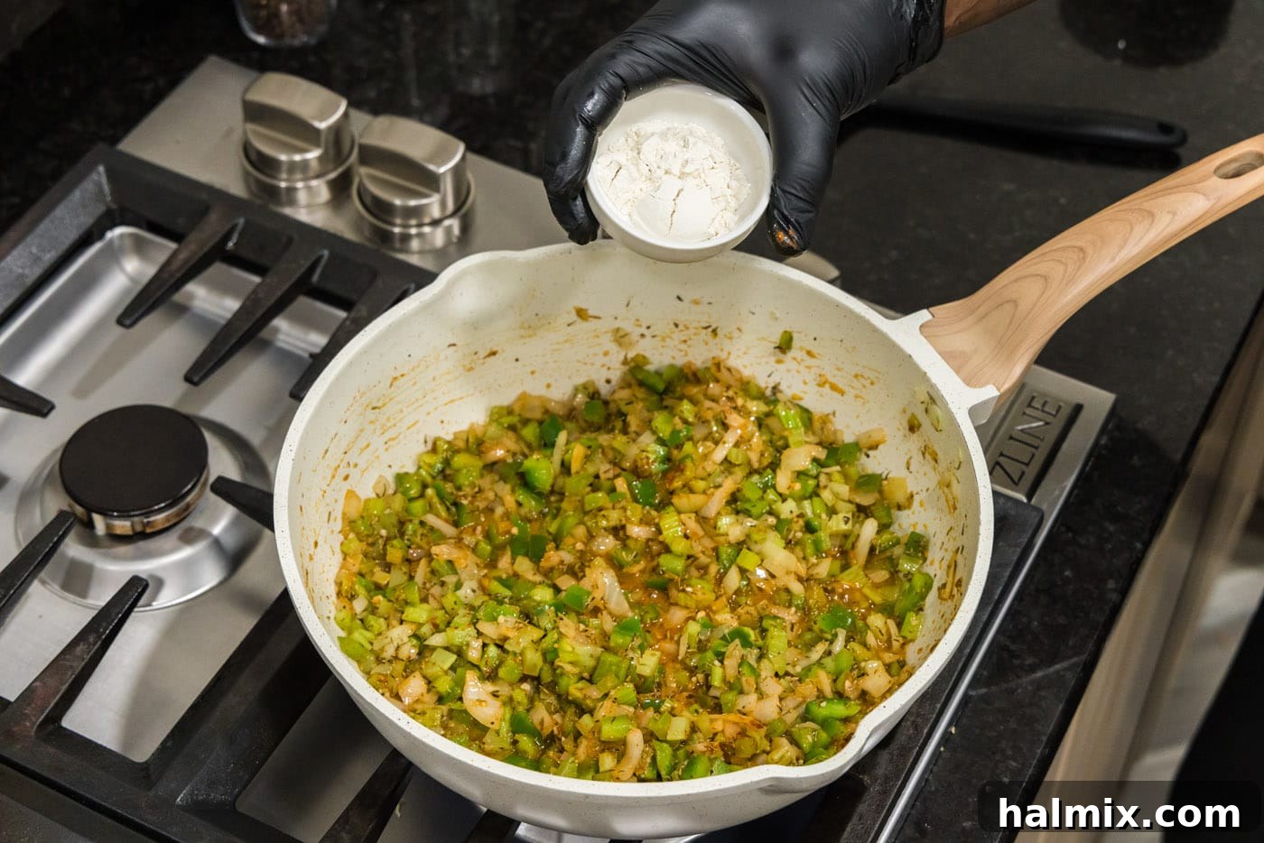 Spicy Shrimp Creole 8 Adding all-purpose flour to the mixture of Cajun Holy Trinity and spices, creating a thickening base.