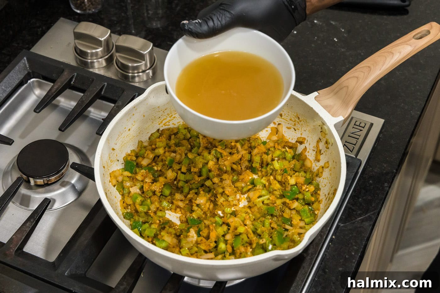 Spicy Shrimp Creole 9 Pouring chicken stock into the skillet, blending with the vegetable and spice base for the creole sauce.