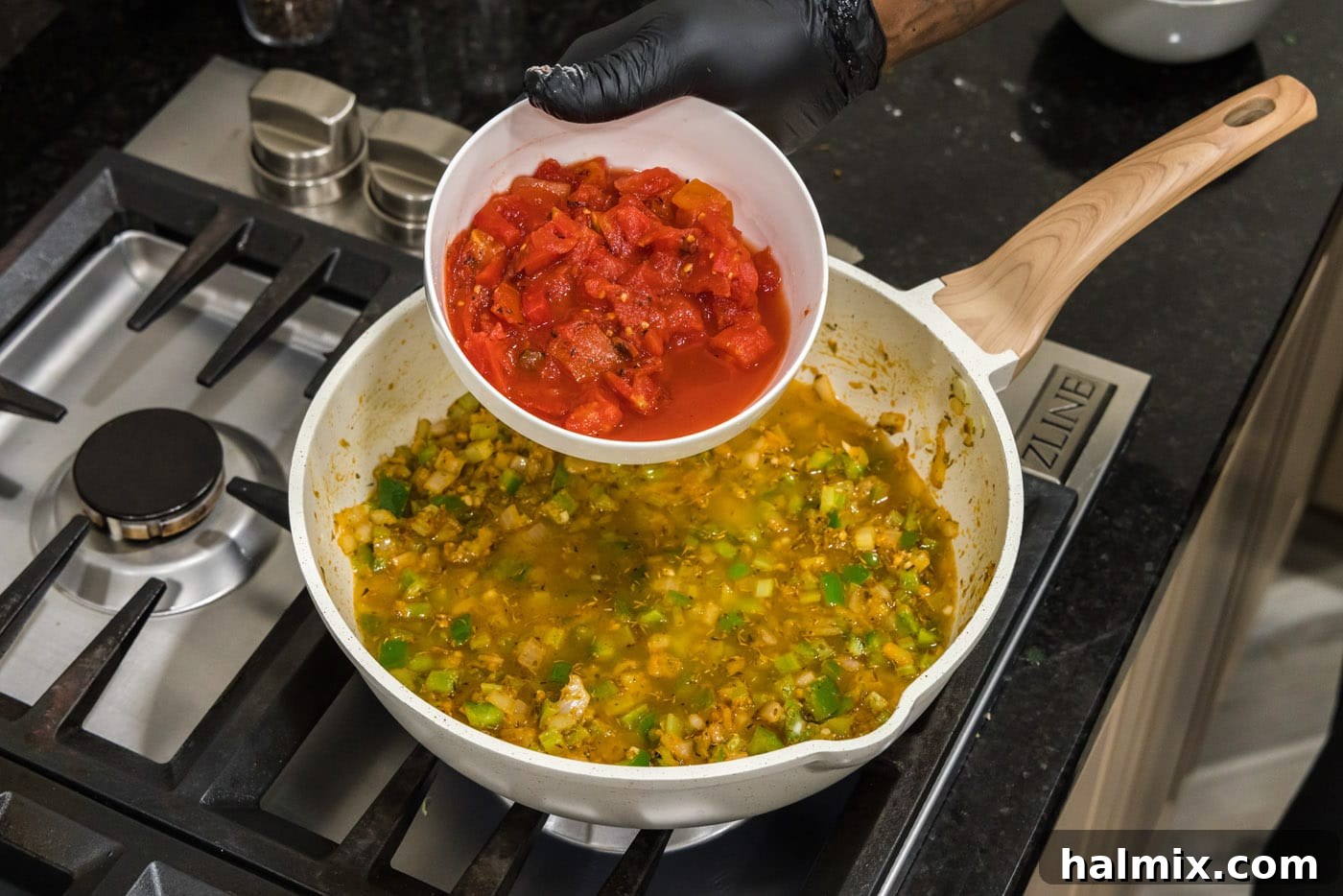Spicy Shrimp Creole 10 Adding fire roasted tomatoes to the simmering creole sauce base, enriching the flavor.