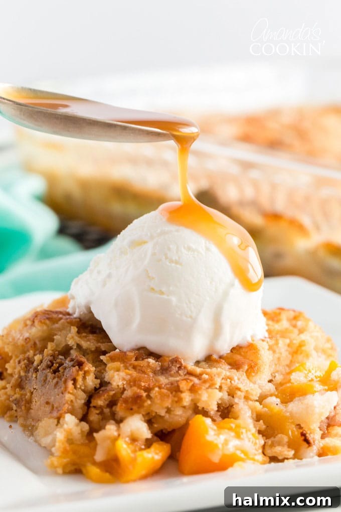spoon dripping caramel onto ice cream on peach cobbler dump cake