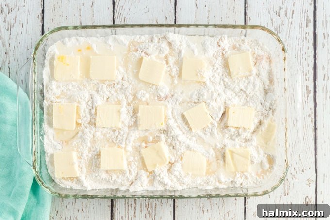 peach dump cake with butter pats on top