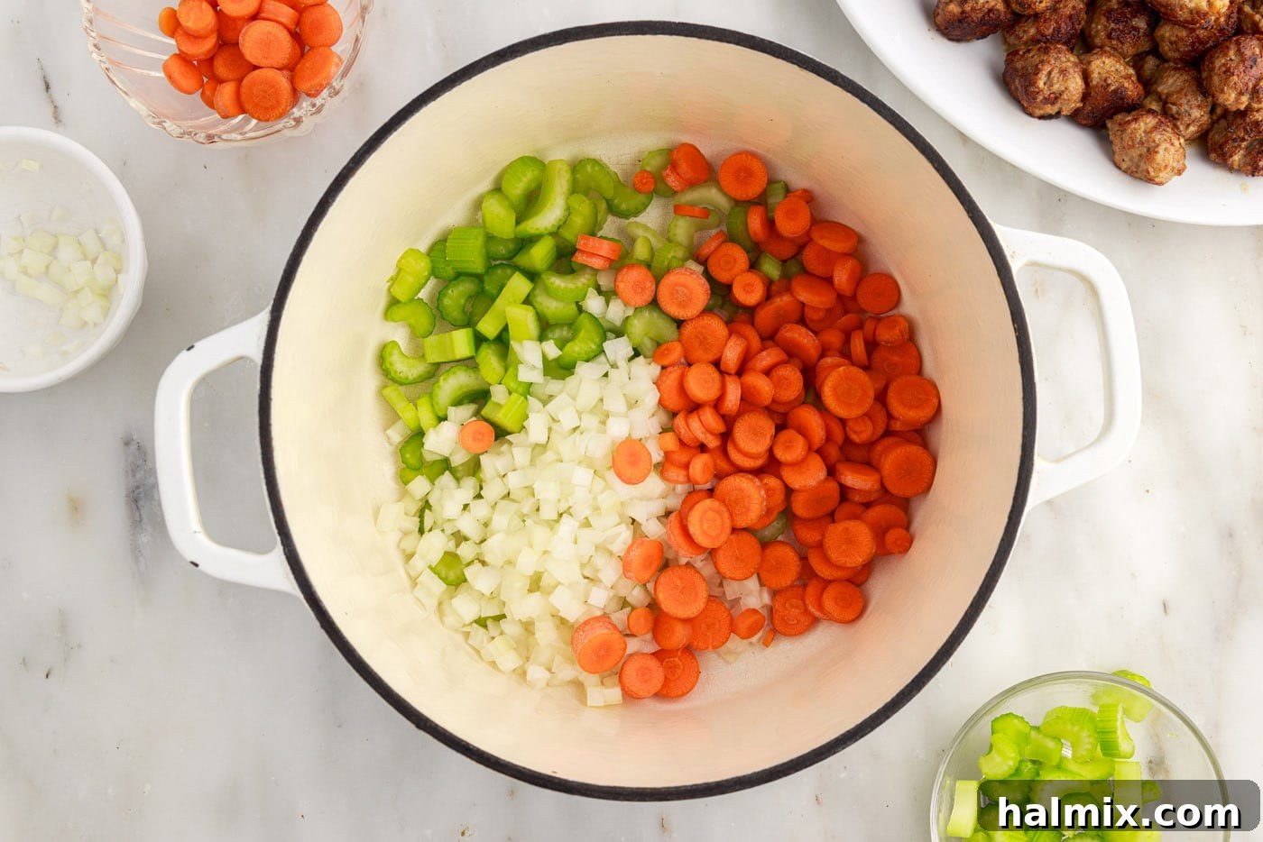 carrots, onion, and celery in a soup pot