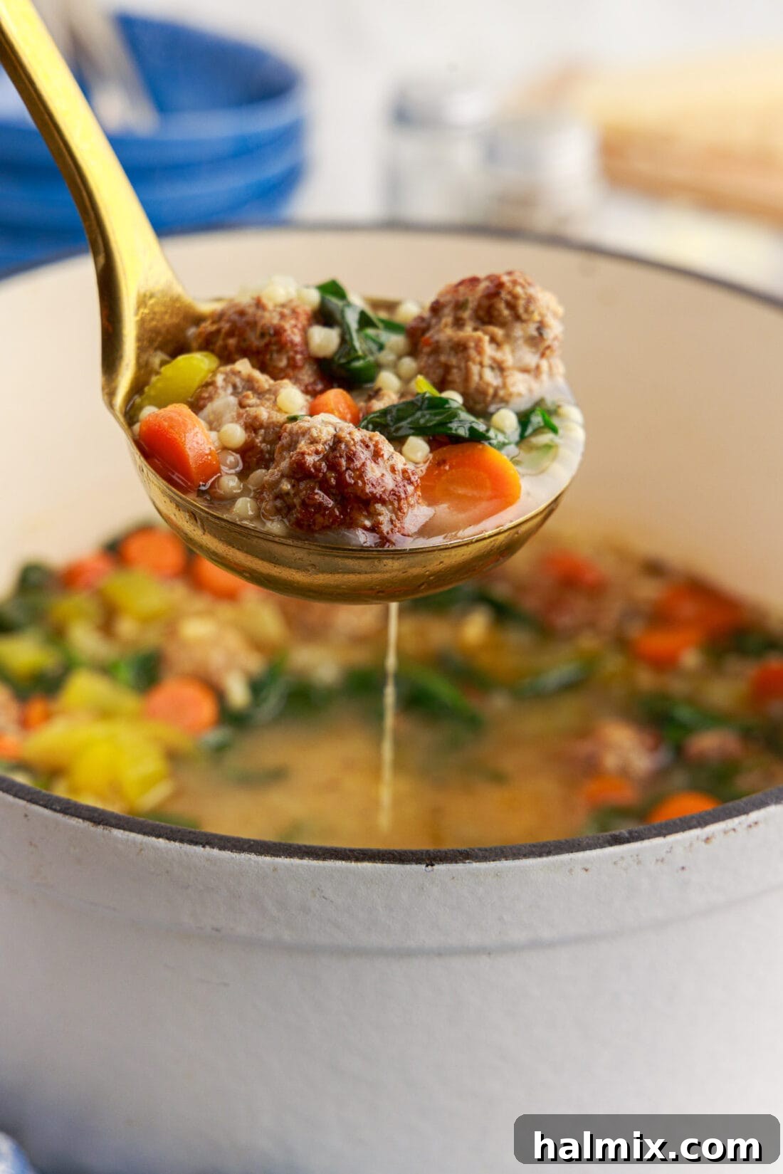 Ladle of Italian Wedding Soup held above a pot of Italian Wedding Soup