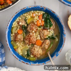 Bowl of Italian Wedding Soup with a spoon in it