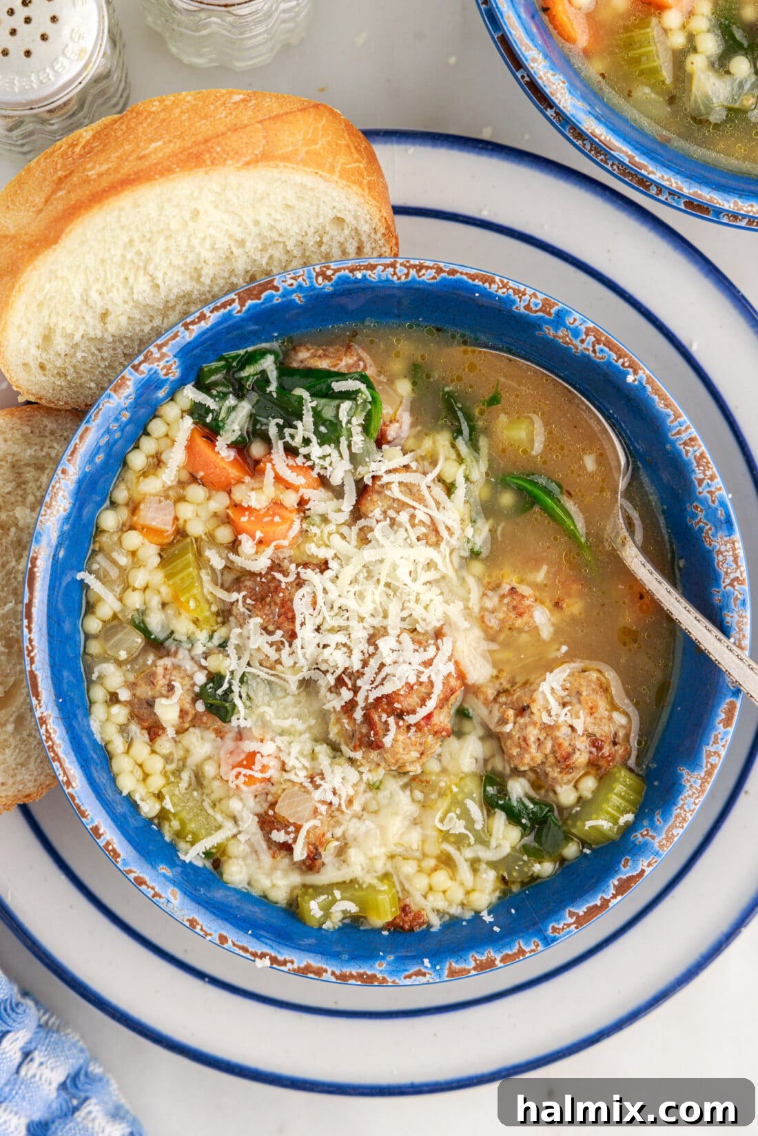 Bowl of Italian Wedding Soup topped with cheese