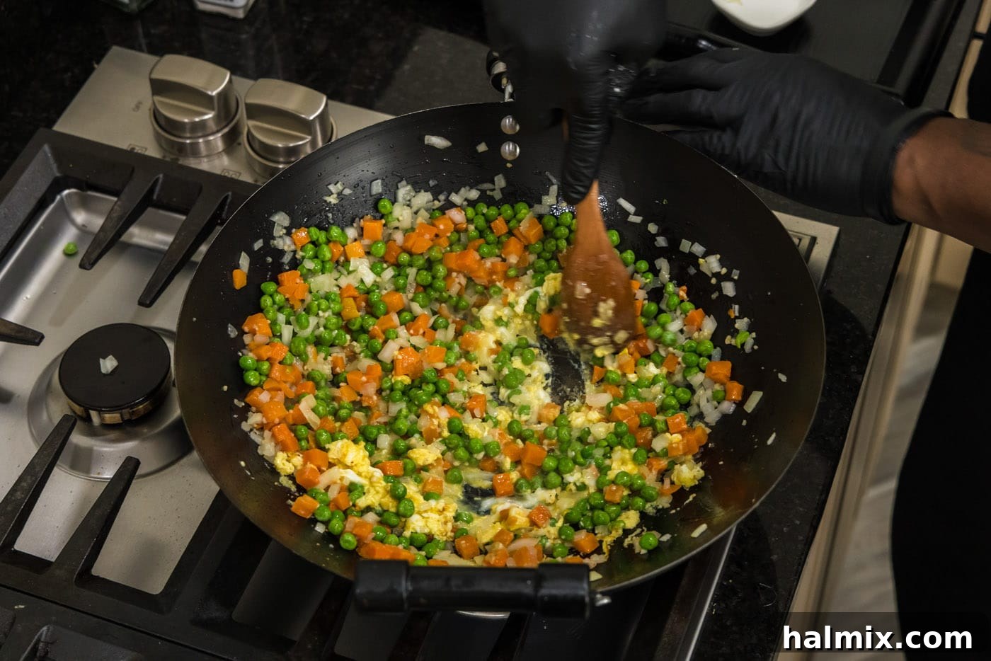 stirring cooked egg into stir fry vegetables