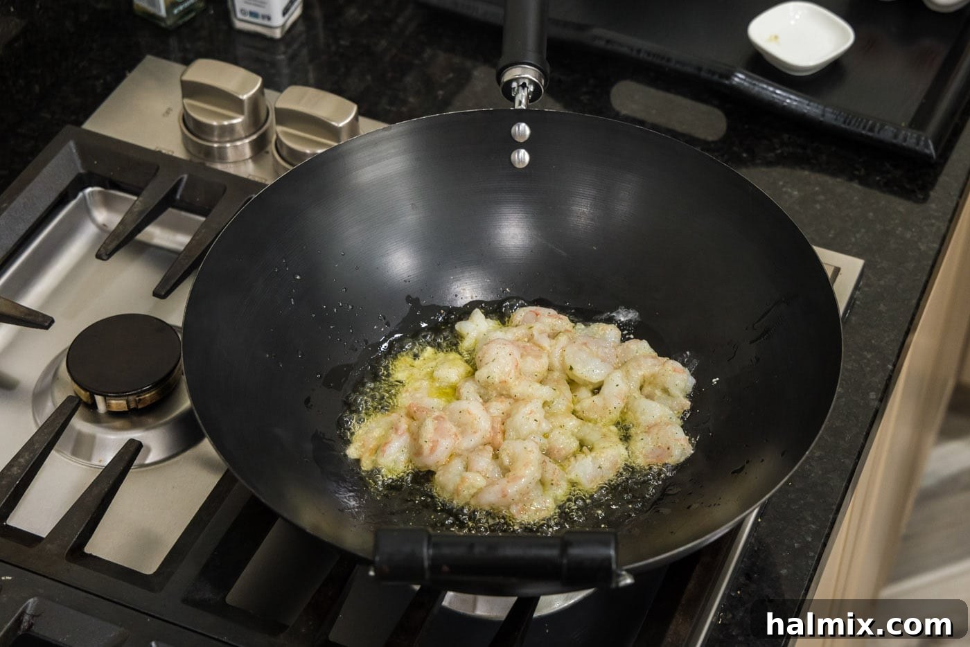 cooking shrimp in a wok with oil