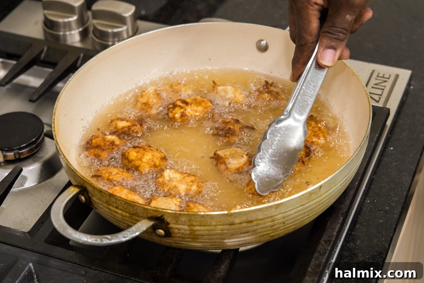 Golden Fried Pork with Tangy Glaze 12 tongs flipping fried pork in oil