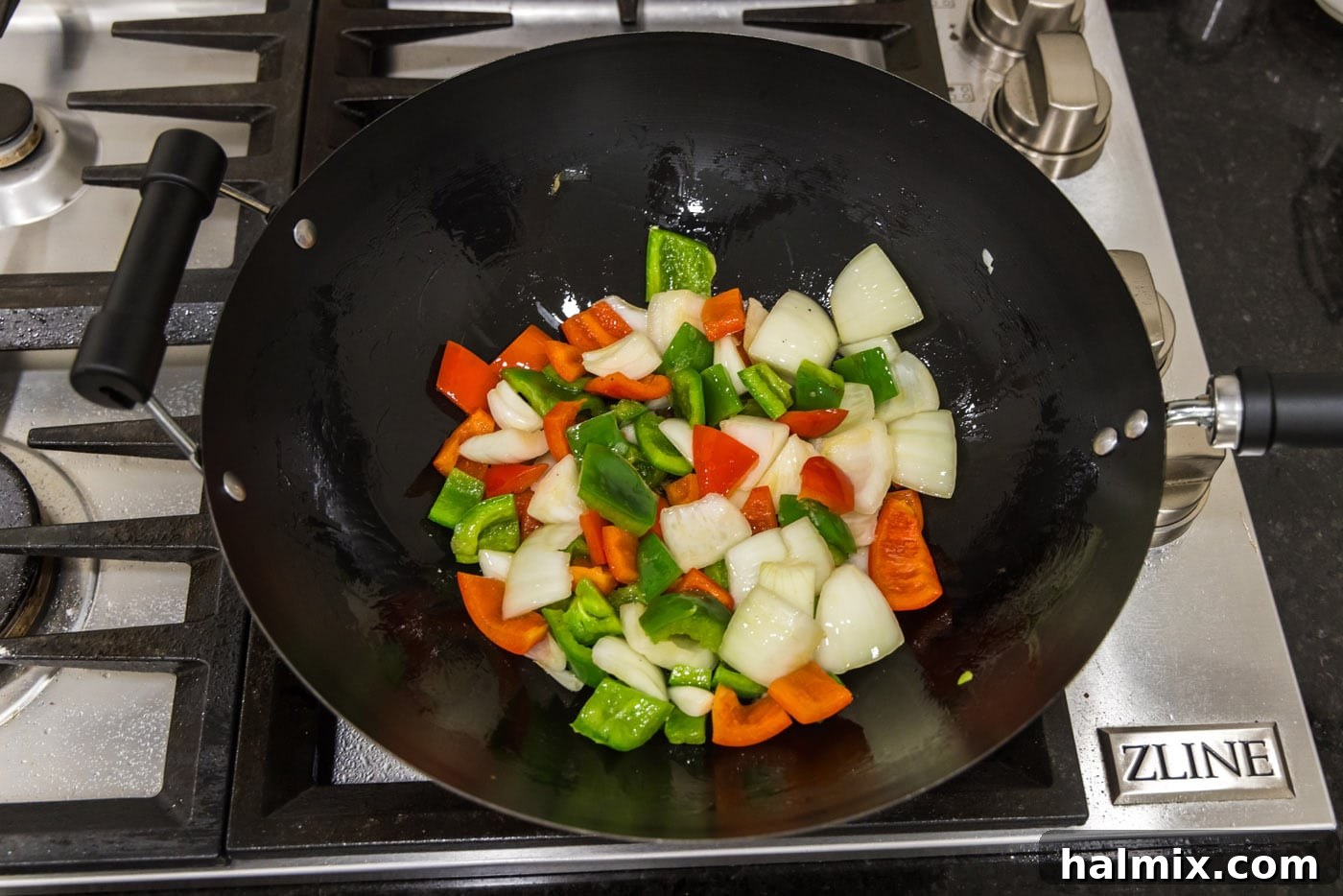 Golden Fried Pork with Tangy Glaze 14 onion and bell peppers in a wok