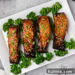 Miso Salmon served on a platter, garnished with green onions and sesame seeds.