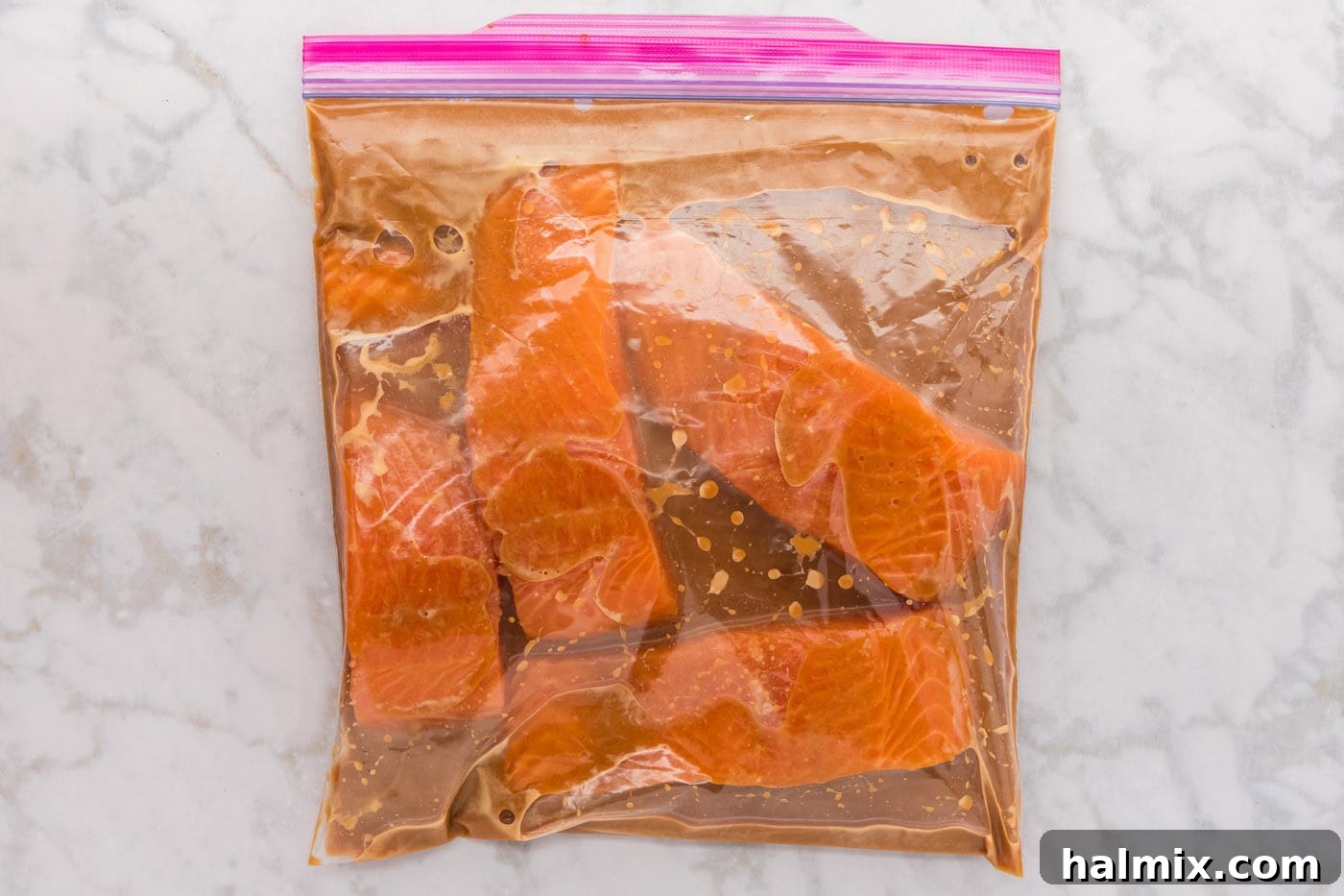 Miso salmon fillets marinating in a gallon zipper bag, absorbing the rich flavors.