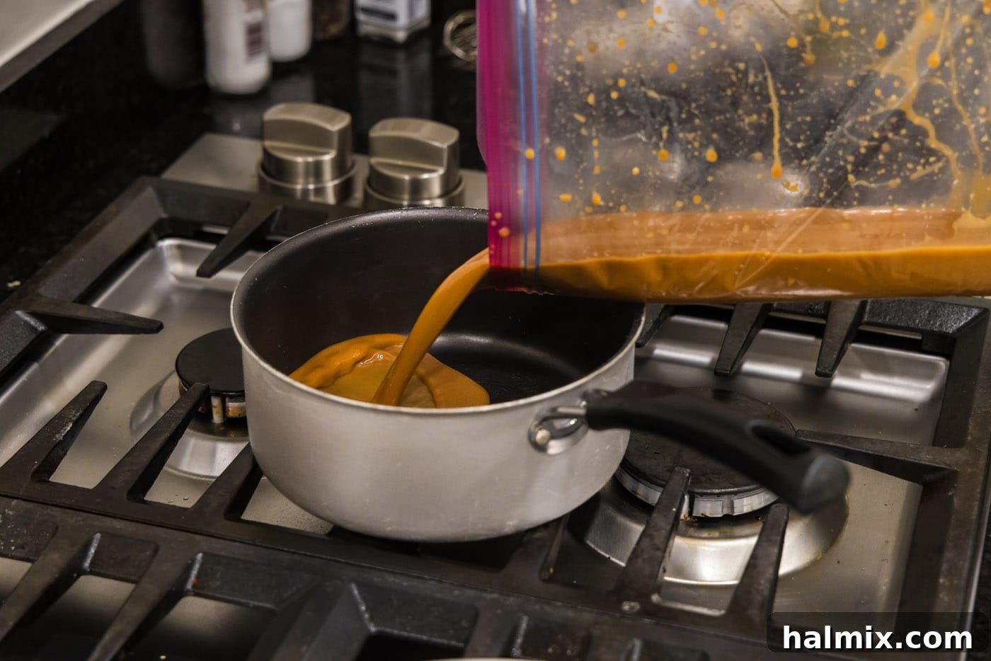 Pouring the flavorful miso marinade into a saucepan to create the glaze.