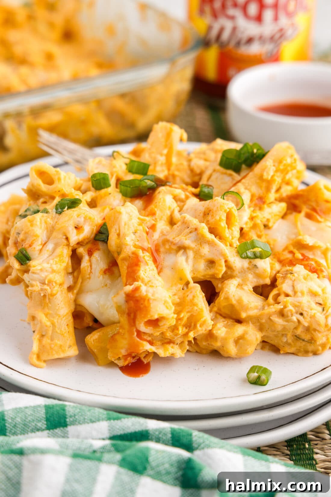 A single serving of Buffalo Chicken Casserole on a plate, garnished and ready to eat.
