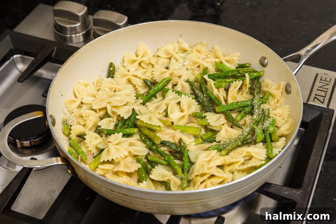 Finished asparagus pasta resting in a skillet, ready to be served.
