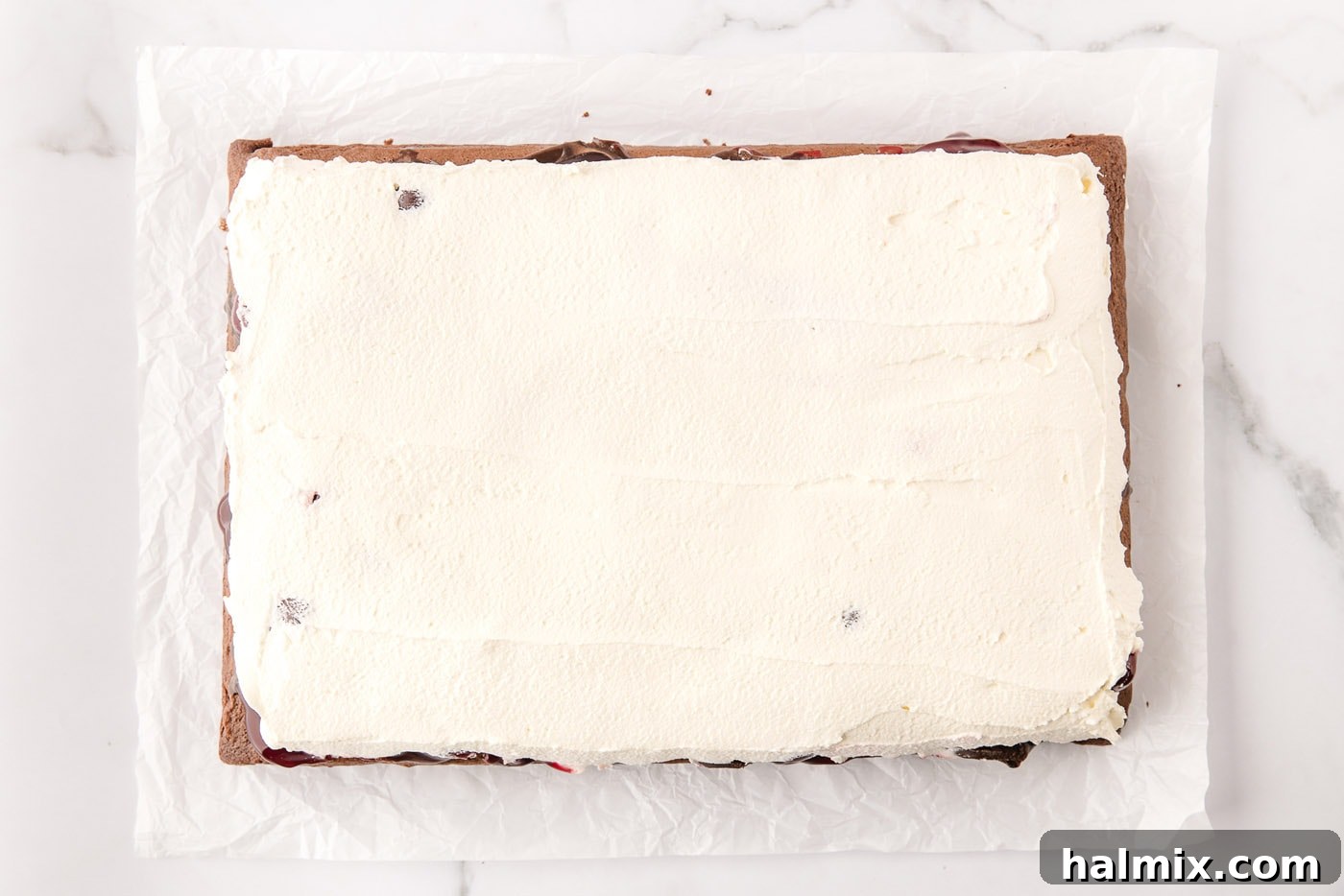 Decadent Black Forest Poke Cake 10 whipped cream topping on black forest poke cake