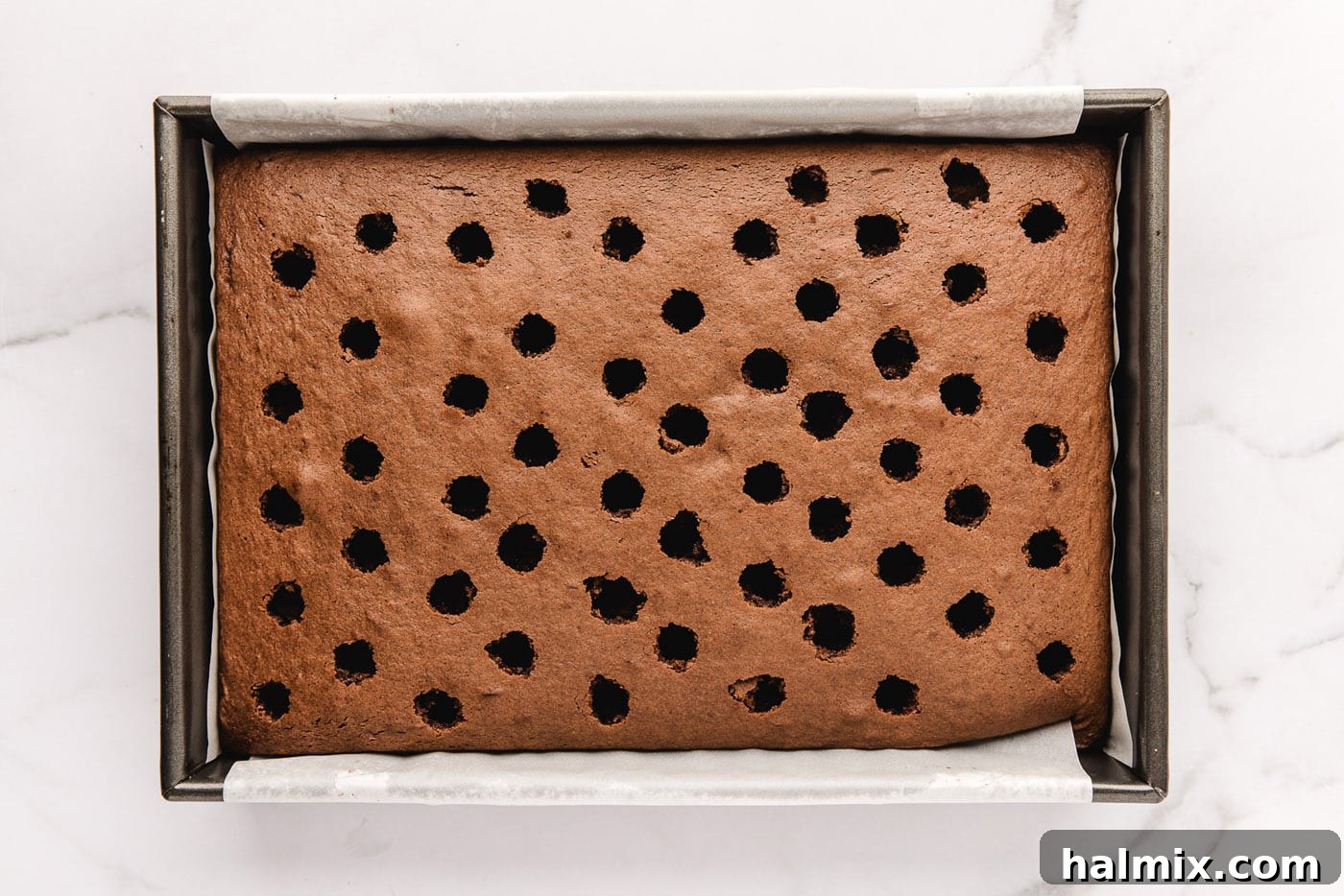 Decadent Black Forest Poke Cake 6 poked holes in chocolate cake