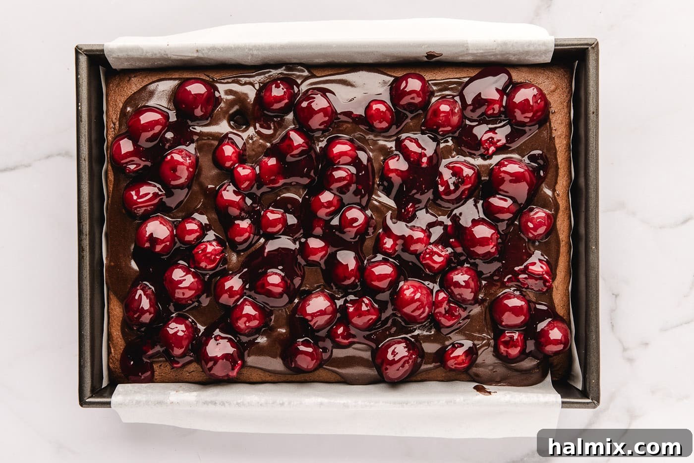 Decadent Black Forest Poke Cake 8 cherry pie filling added on top of fudge sauce and chocolate cake