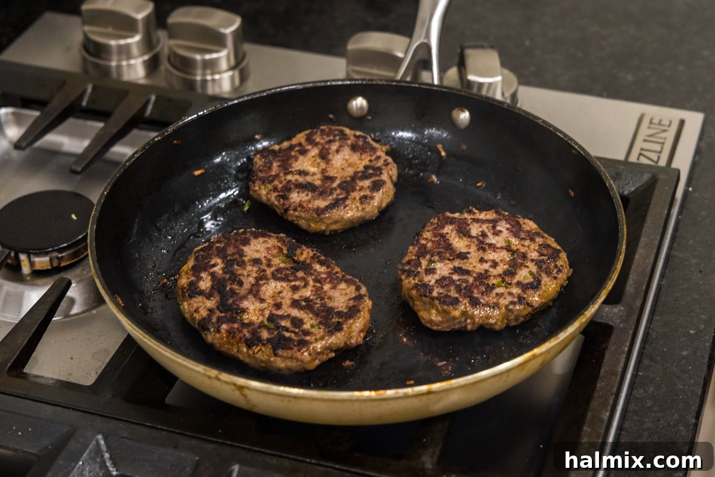Mighty Buffalo Burger 11 Finished buffalo burgers, beautifully browned and cooked, resting in the skillet after searing.