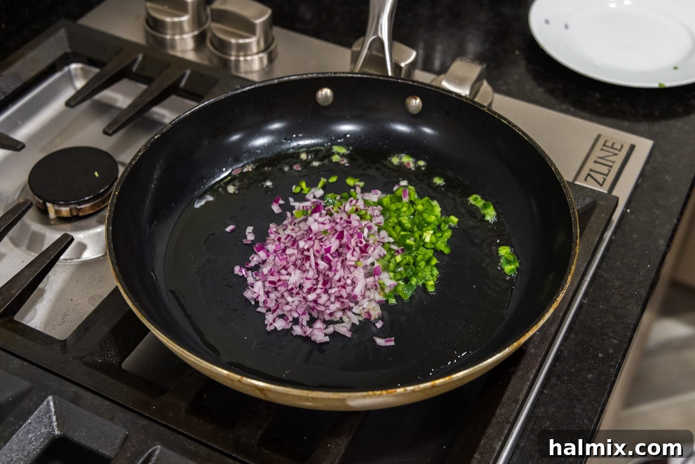 Mighty Buffalo Burger 5 Finely chopped red onion and jalapeno peppers sizzling in a skillet with olive oil.
